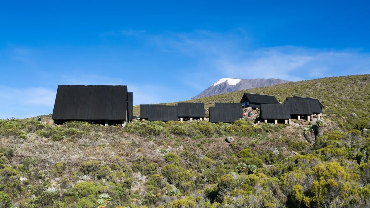 The huts of Horombo Hut on the moorland below Kibo, a sight on Kilimanjaro climbing tours
